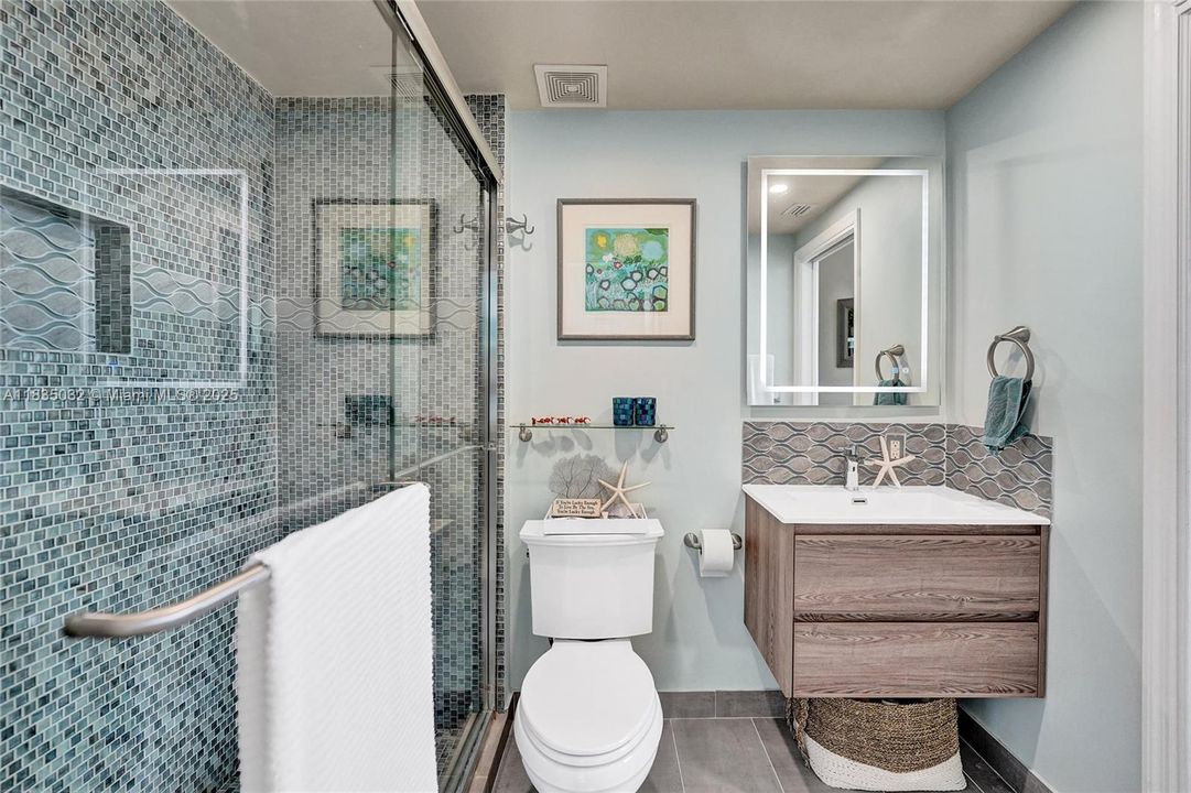 Beautifully designed bathroom with tiled walls