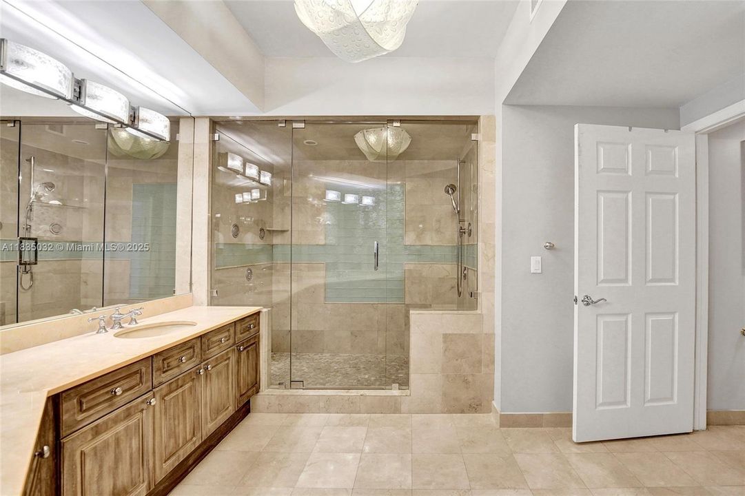 huge primary bathroom with marble floors