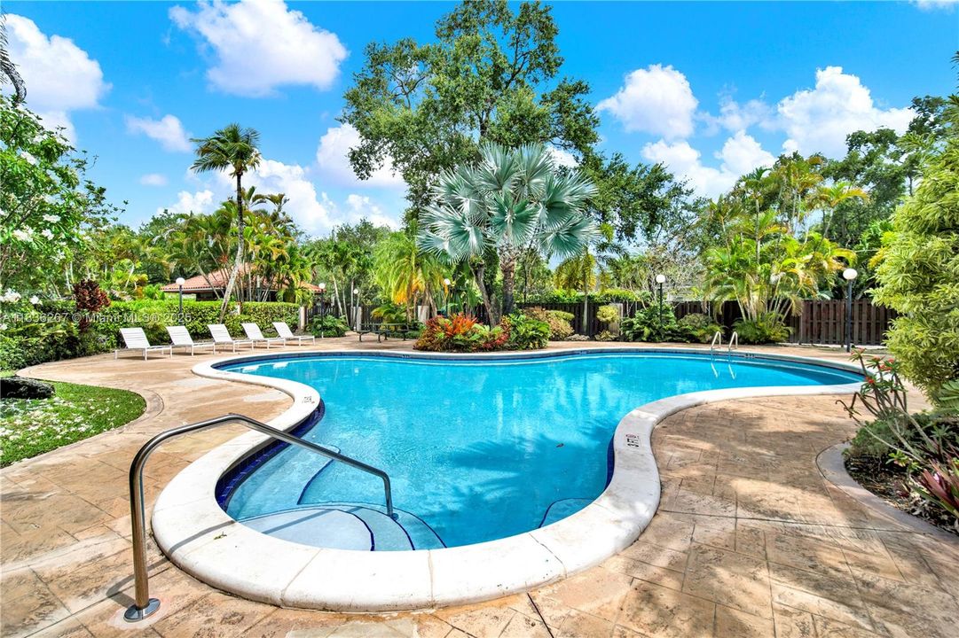 Secondary smaller pool surrounded by tropical flowers and plants