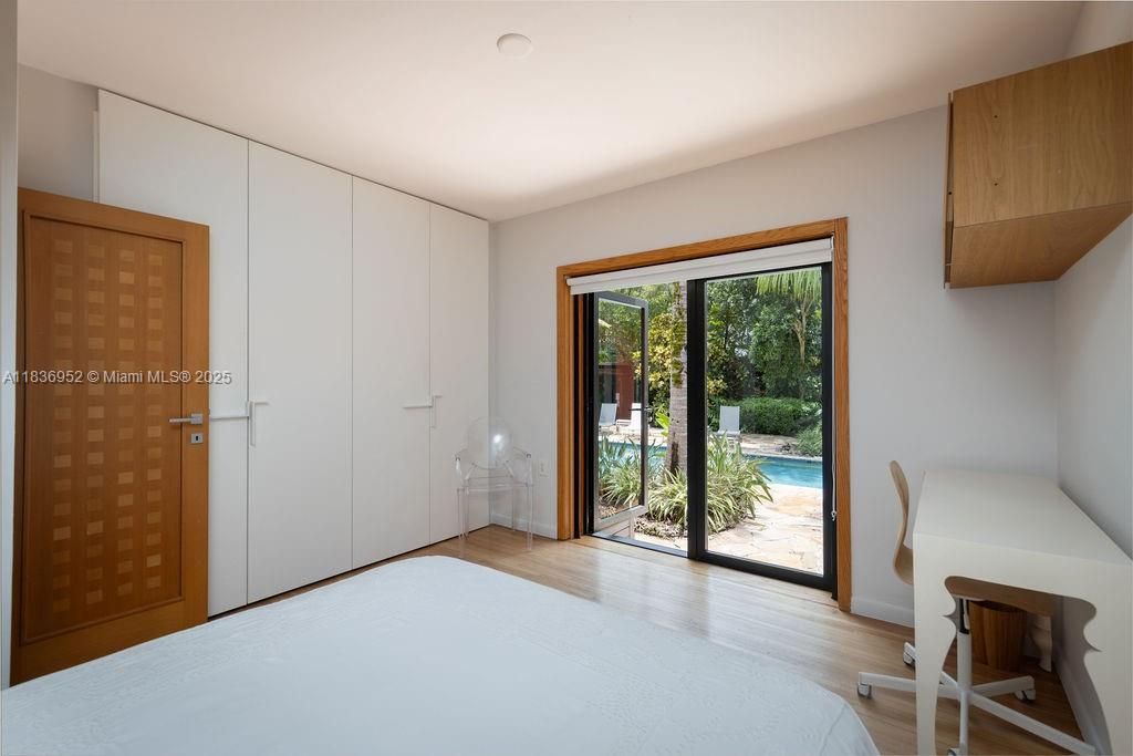 Bedroom 2 with view and exit to pool and garden
