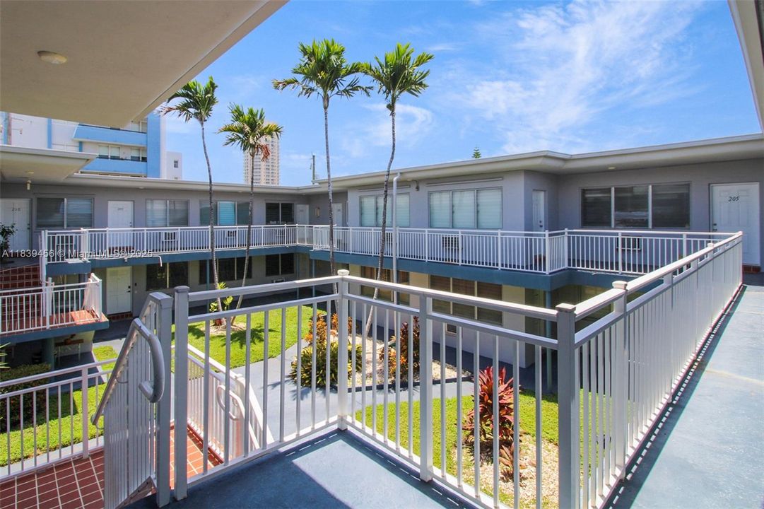 Corner unit inside entry gate and up the stairs.  Only one adjacent unit.