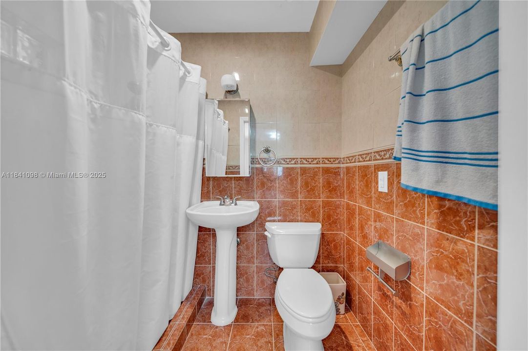 Located within one of the bedrooms, it was thoughtfully designed to be shared by both adjacent rooms.