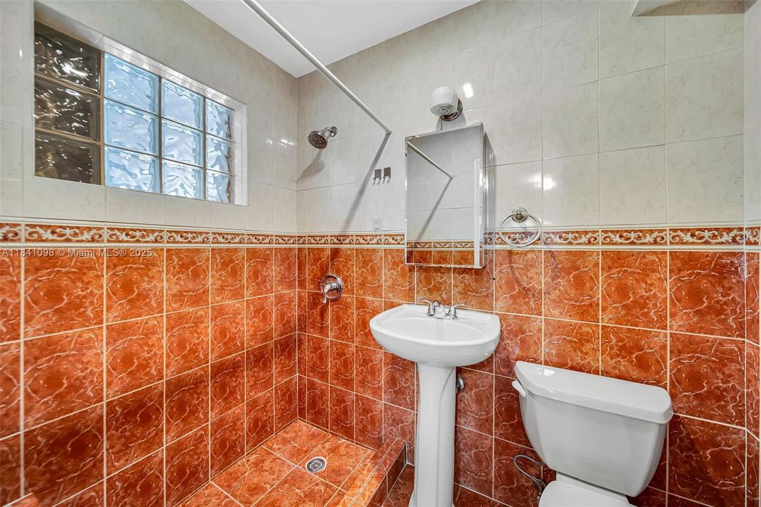 Located within one of the bedrooms, it was thoughtfully designed to be shared by both adjacent rooms.