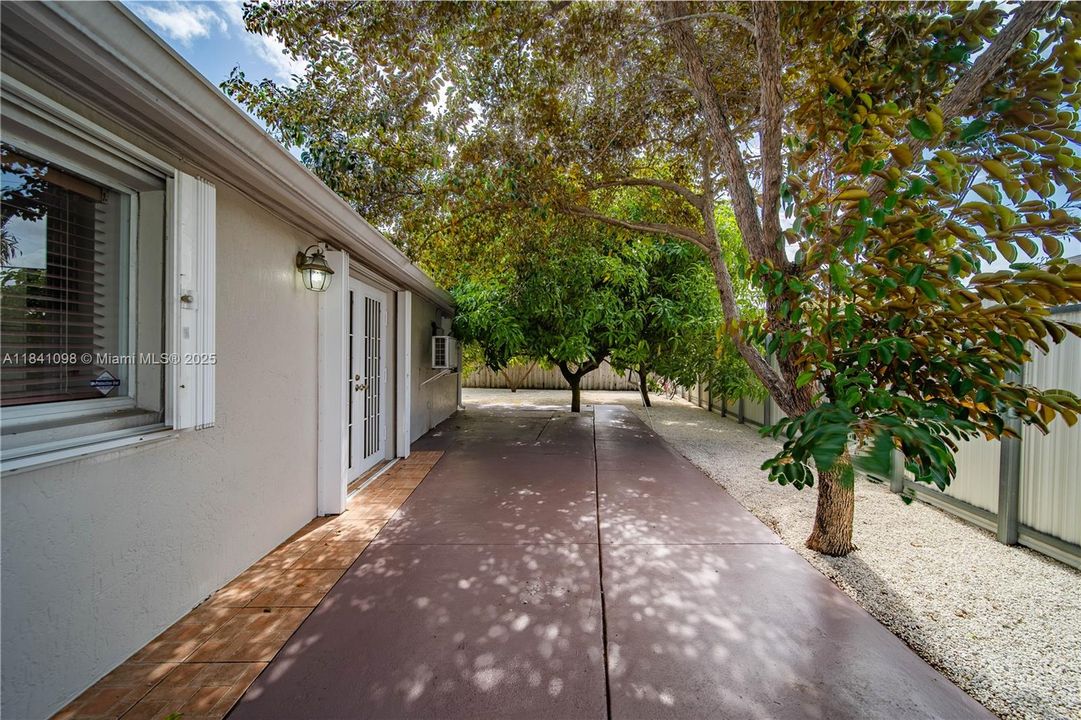 west side of house: Spacious stained concrete patio just off the kitchen and family/dining area—perfect for outdoor dining and entertaining.