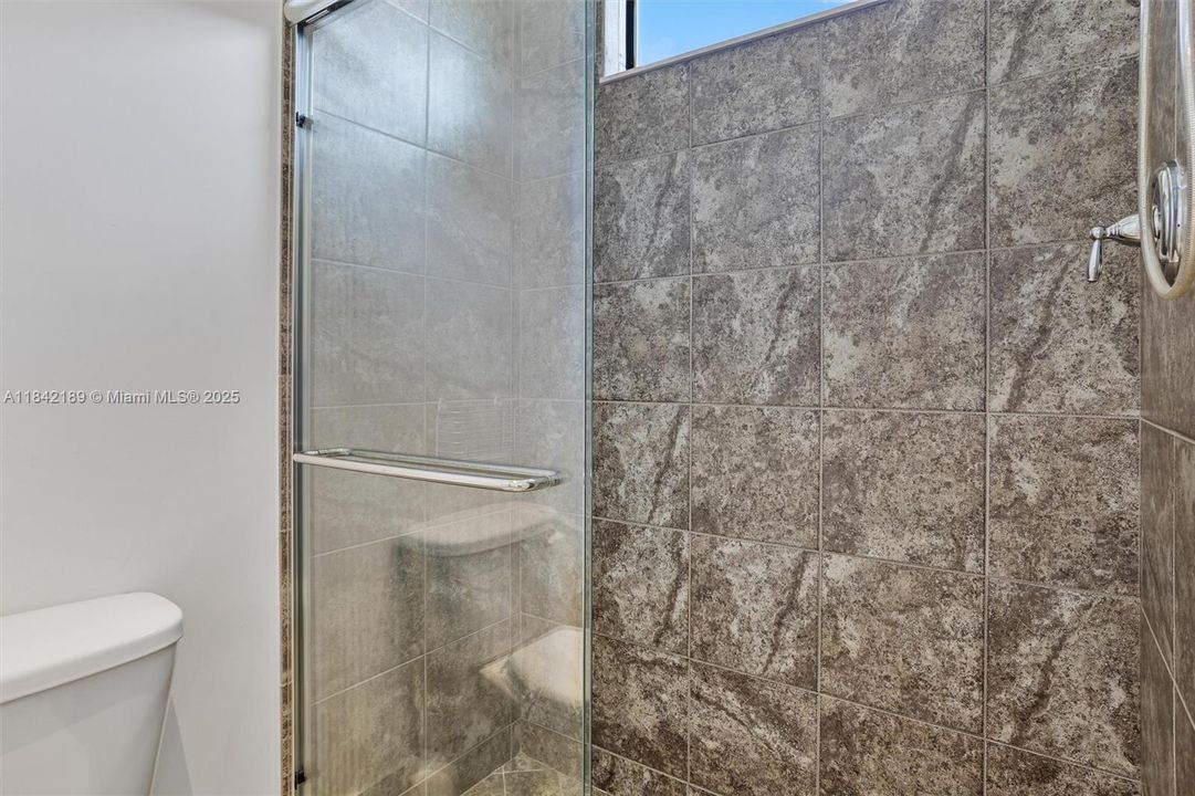 Shared Bathroom with Glass Enclosed Shower