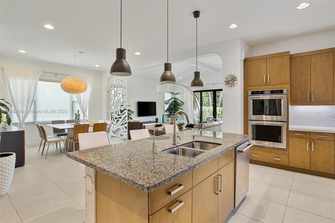 Beautiful Kitchen Isle with Overhead Lights + Wall Ovens