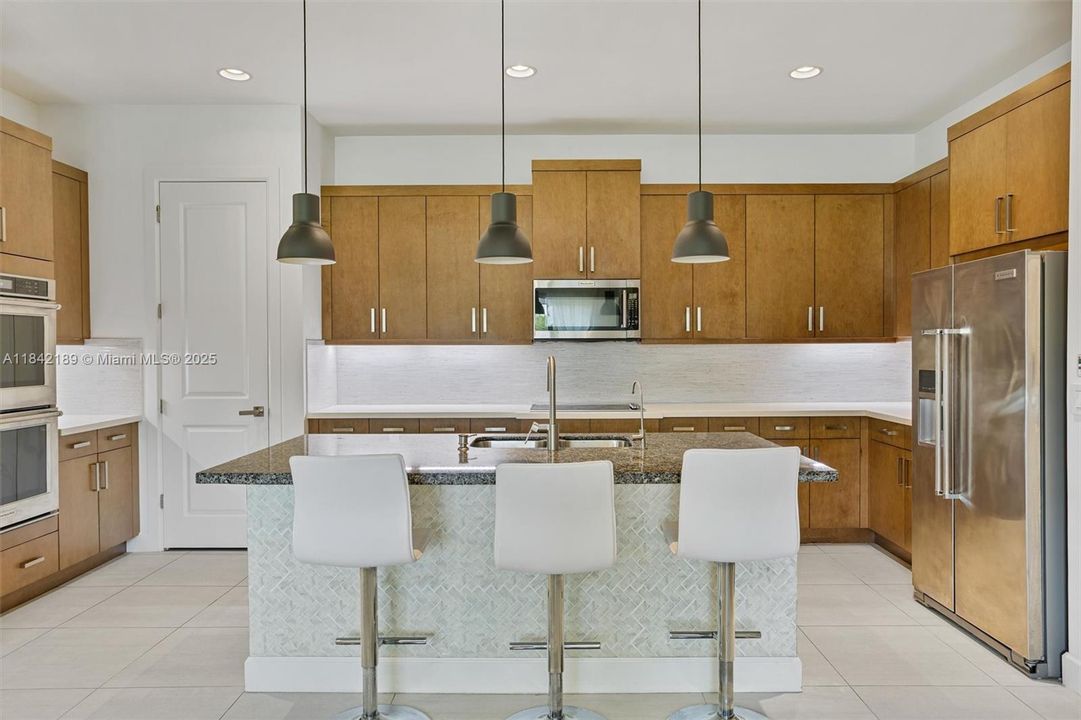Panoramic View of Kitchen - Wood Cabinets, SS Appliances & Isle Seating