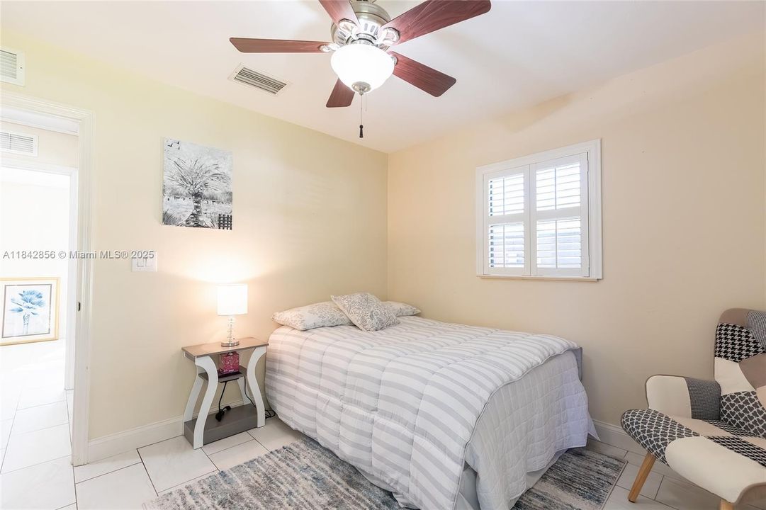 Corner guest bedroom with 2 windows & a huge closet the length of the wall overlooks the back yard & sunset.