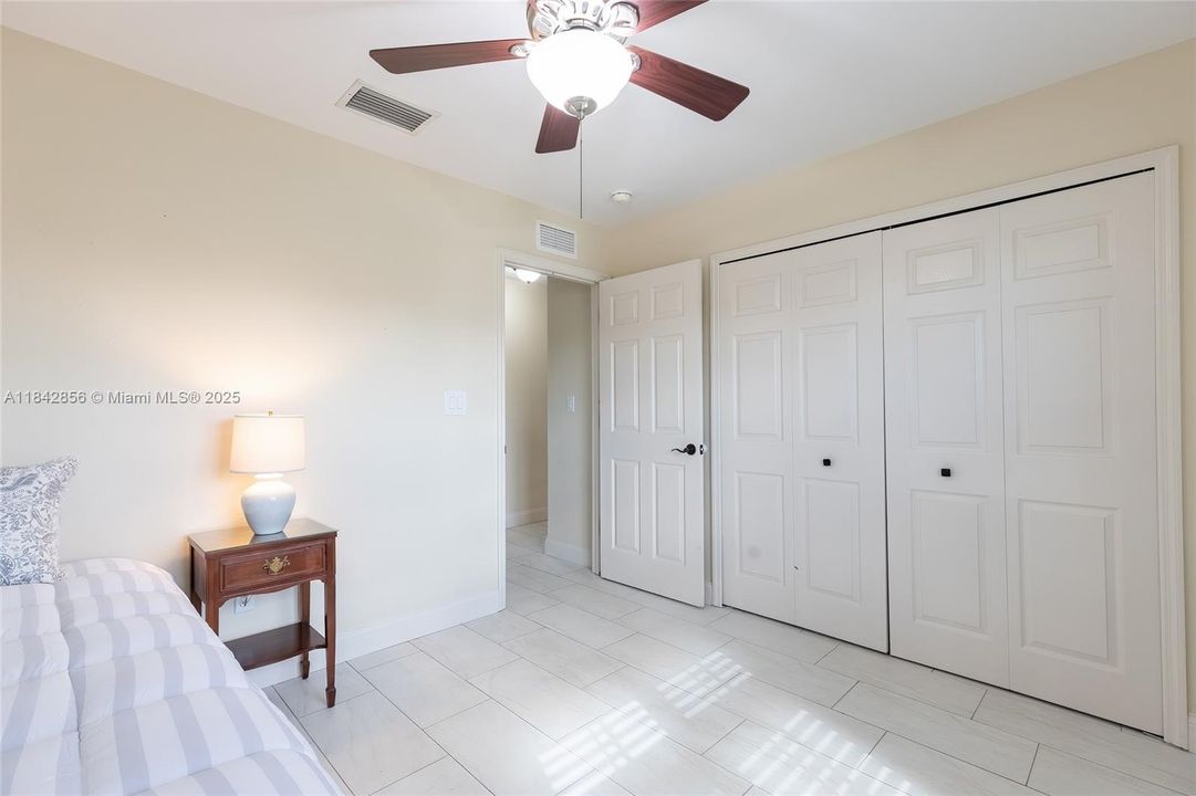Corner guest bedroom with 2 windows with morning sun & a huge closet the length of the wall overlooks the front yard. Huge closets along the entire wall.