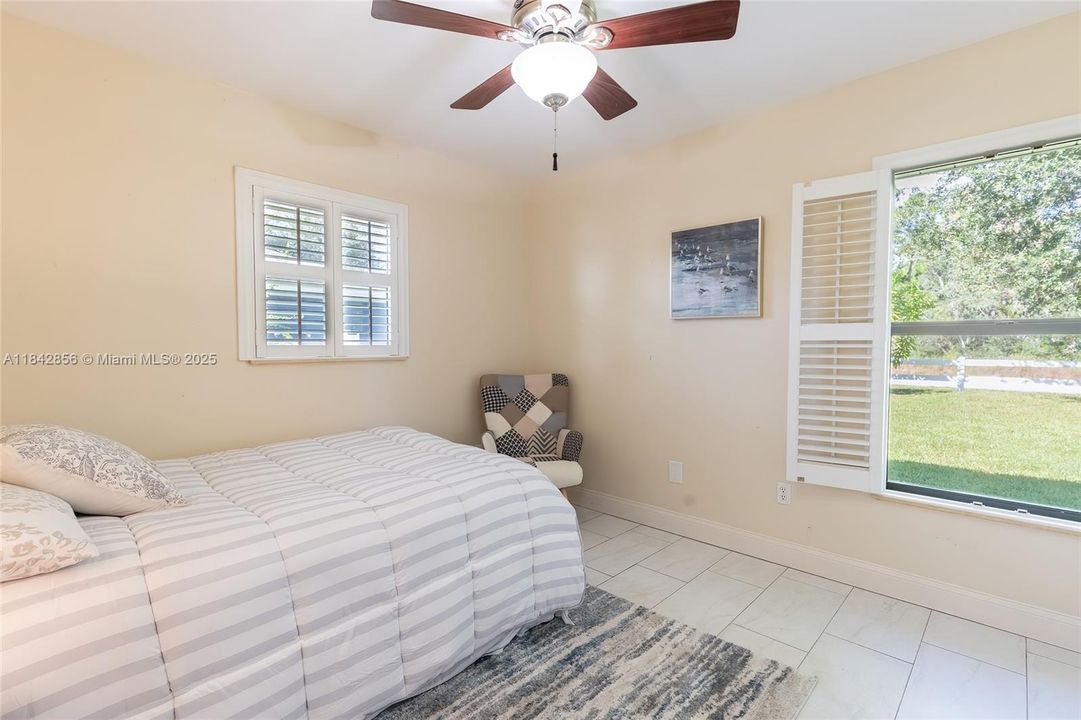 Corner guest bedroom with 2 windows & a huge closet the length of the wall overlooks the back yard & sunset