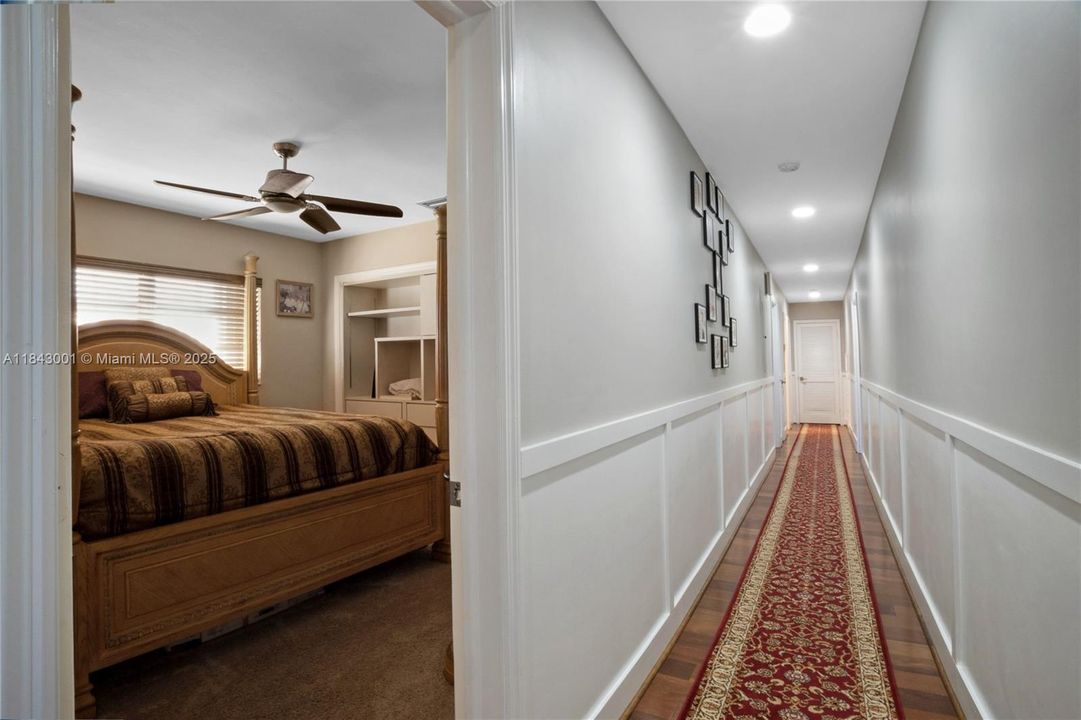 Ground floor hallway with 3 bedrooms and 2 baths