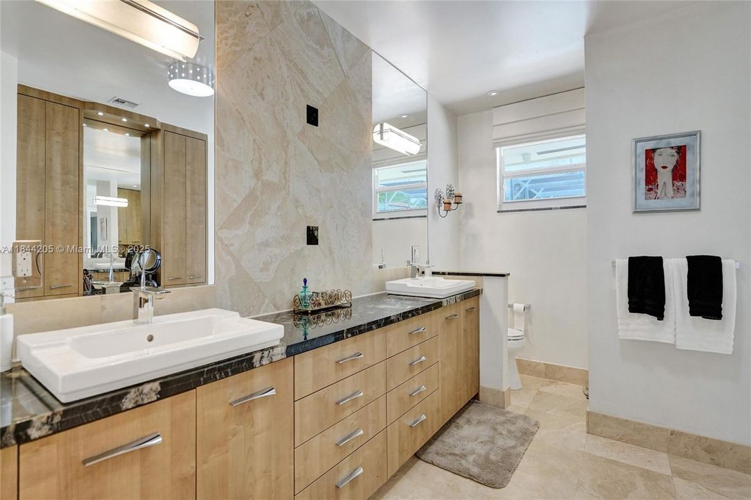 Dual sinks with tiled walls and mirrors