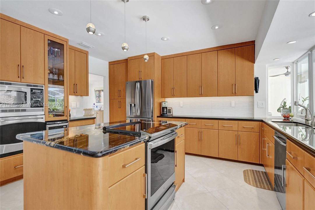 TWO ovens and built in microwave, new island granite top and new range!....Glass backsplash is new as well!