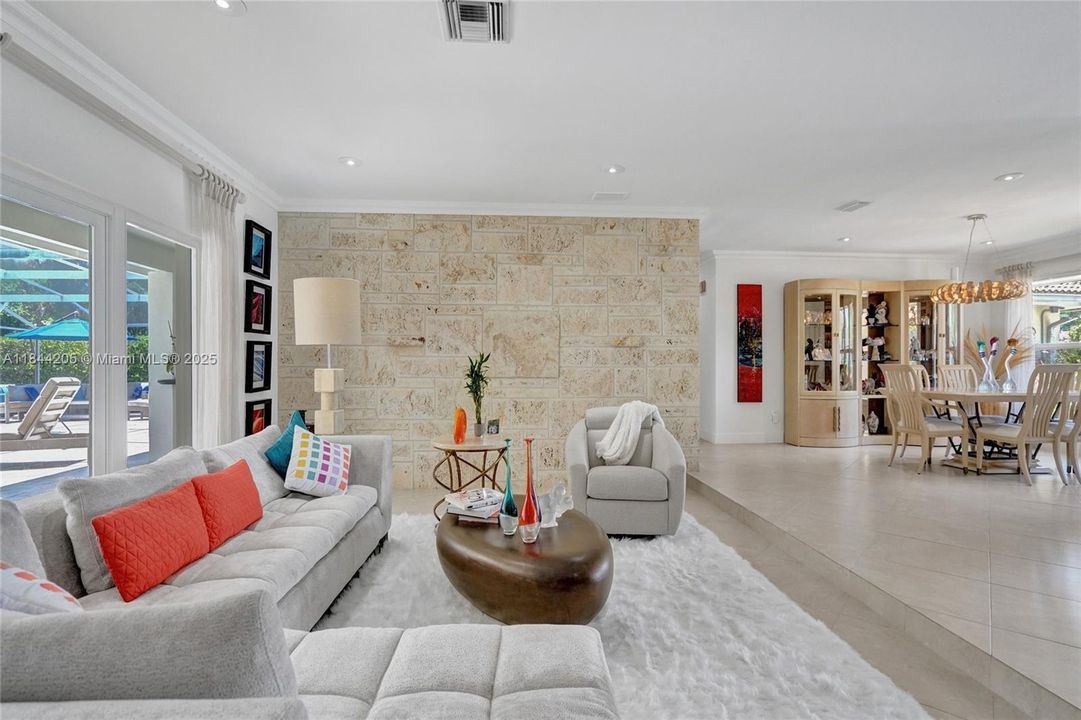 Enjoy sitting in the living area that overlooks the patio and pool