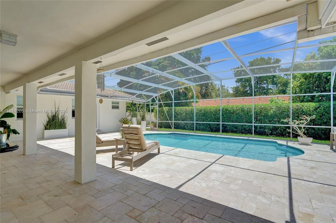 The large overhang is perfect for entertaining....especially when the rain comes!  Side glass door for entry into the home as well as the 3 sets of French doors.