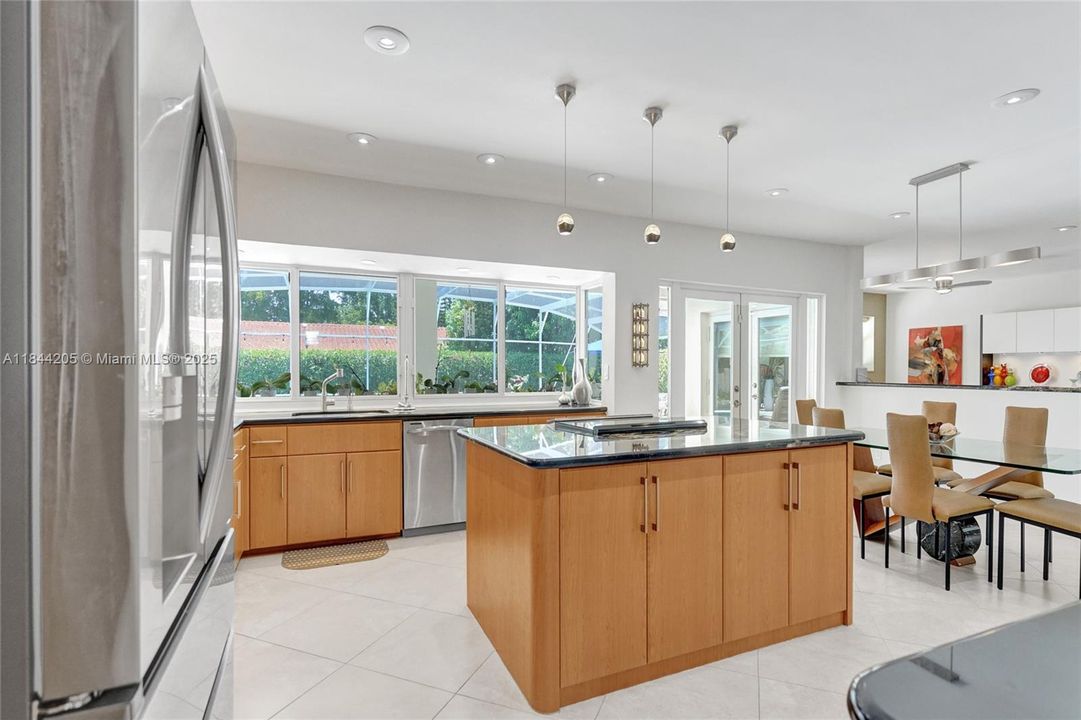 Newer refrigerator and brand new range and granite island top