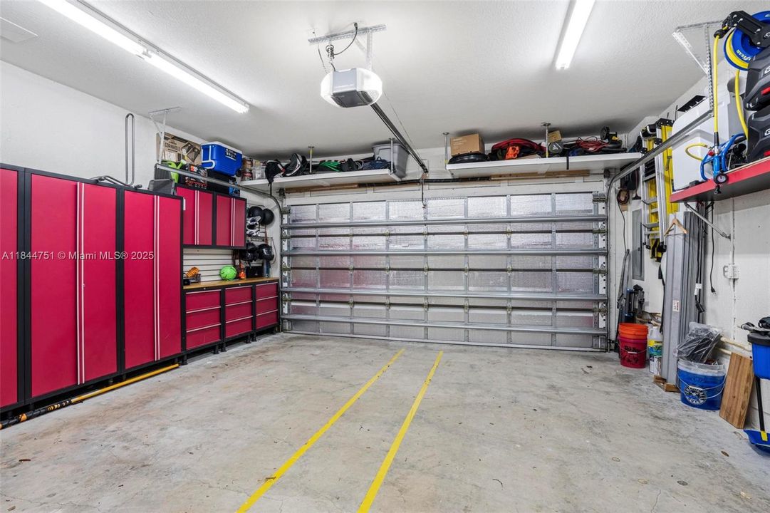 EV- charging station is not included in sale of home. But you do get the beautiful Home Depot Garage Storage System.4 uppers, 4 lower and 3 cabinets 24-Gauge Stainless Steel Garage Storage System in Deep Red. Red Refrig is NOT staying with house