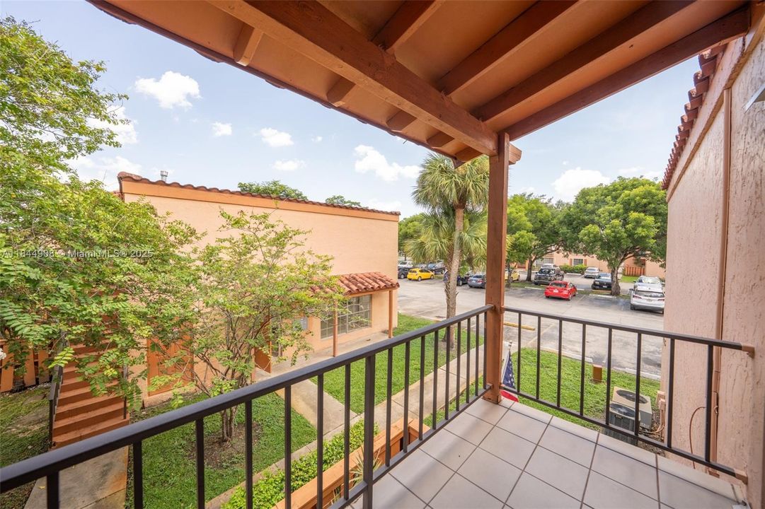 View of community laundry and parking from balcony