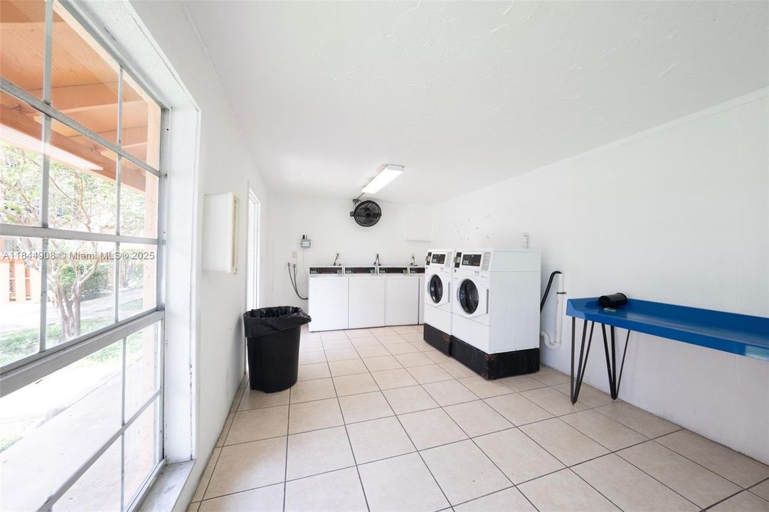 Well-lit laundry room close to unit