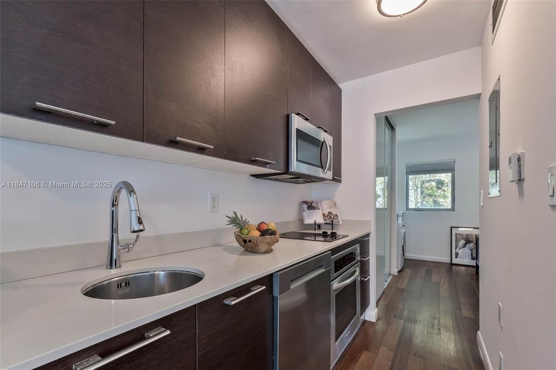 Modern Italian kitchen, stainless appliances, quartz counters