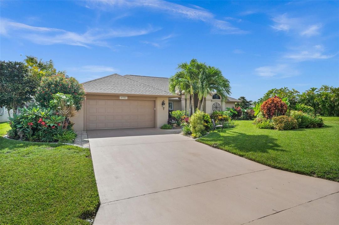 Plantation-style palms frame the front entrance.