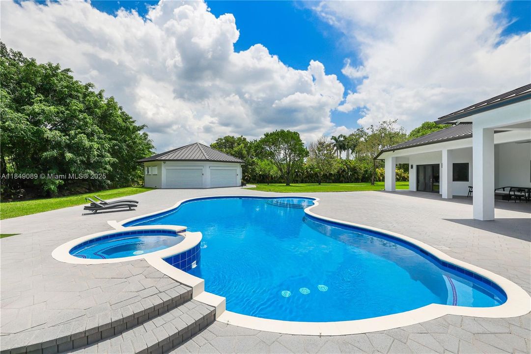 Resort-style pool with brand new Diamond Brite finish, chlorine system, and heat pump spa.