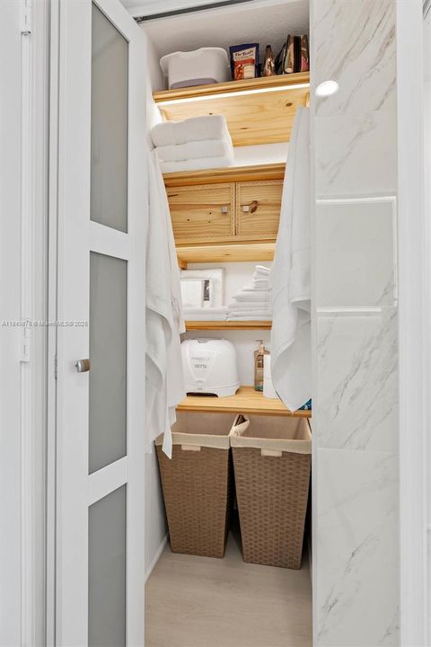 Primary Linen closet located inside bathroom