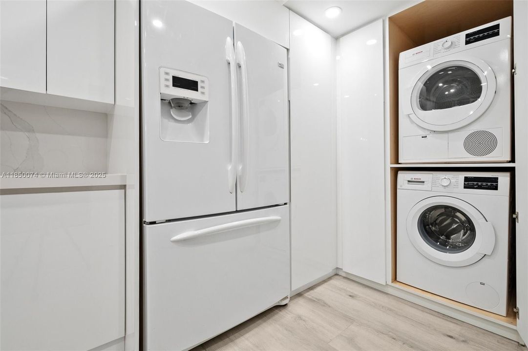 Features ventless Bosch clothes washer and dryer inside unit.