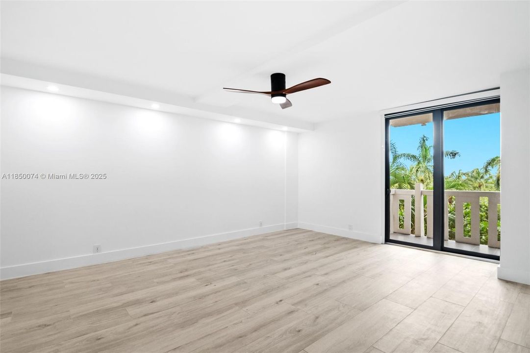 Luxurious master suite features balcony access.