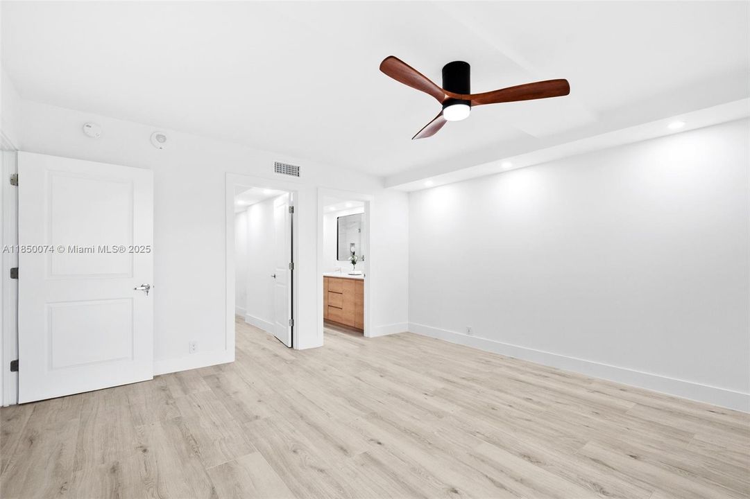 Luxurious master suite features balcony access.