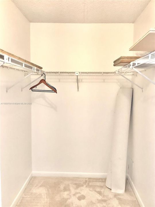 Primary bedroom walk-in closet