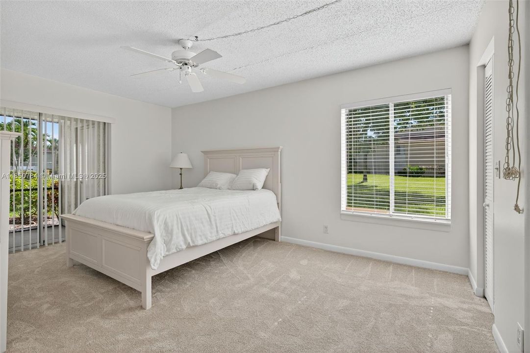 Primary bedroom with sliders to screened patio