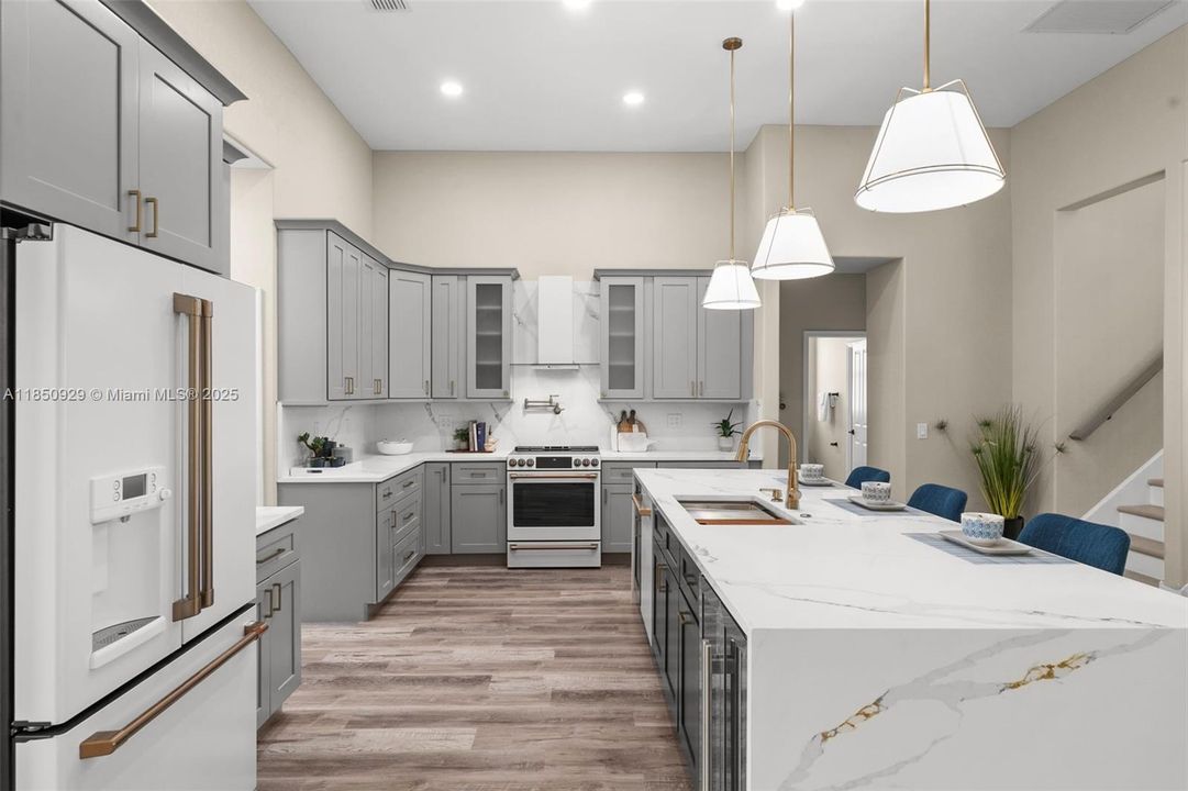 Quartz counter tops, shaker cabinets, cafe appliances and lots of room to create wonderful meals.