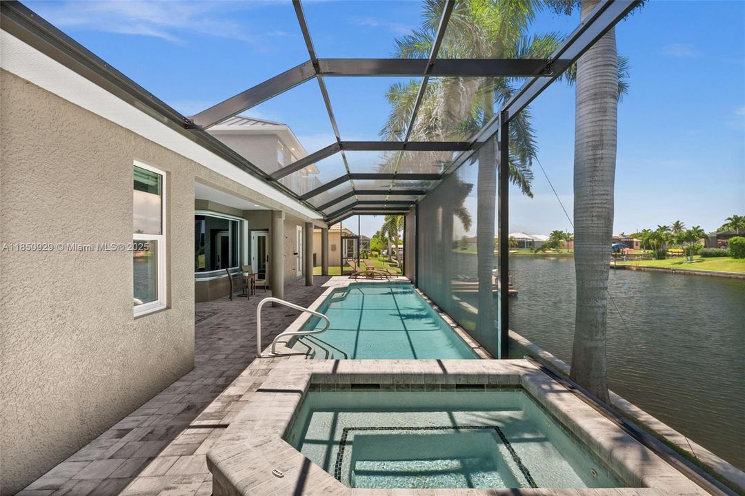 View of spa and pool along oversized Gulf Access canal