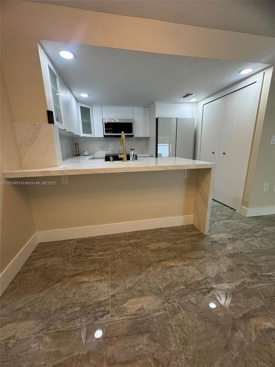 Formal Dining Room and Oversized Quartz Eat In Counter