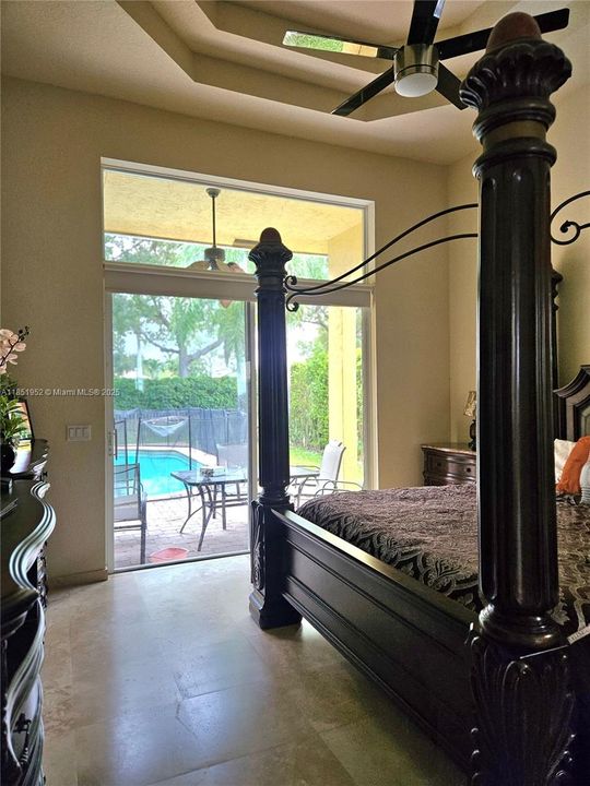 Primary ensuite with sliding doors to patio and pool