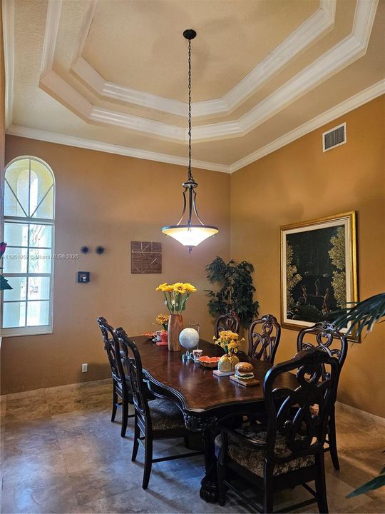 Formal Dining with Tray Ceiling and Arched Windows