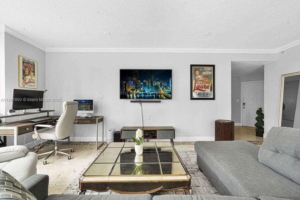 Bright and modern living area featuring floor-to-ceiling windows, abundant natural light, and open-concept design perfect for entertaining. Enjoy elegant finishes, neutral tones, and city views in this Miami high-rise condo near Biscayne Bay.