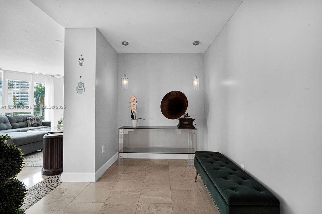 Elegant hallway with modern flooring and neutral color palette, offering a welcoming transition between rooms.