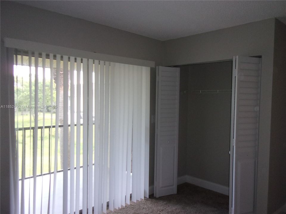 2nd bedroom is airy and opens to the screen patio facing SE