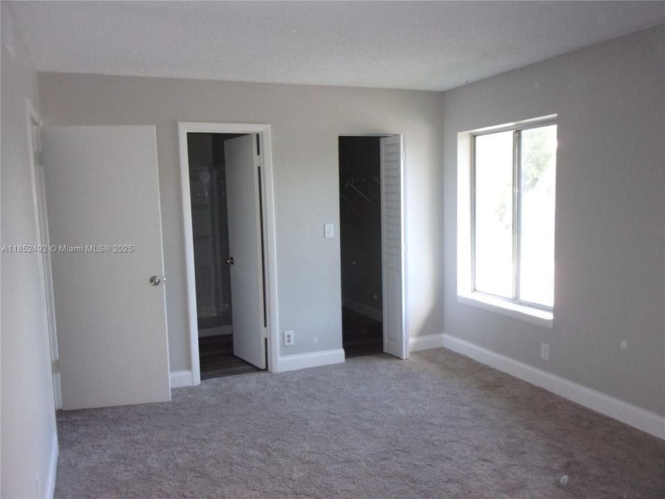Bright primary bedroom with walk in closet