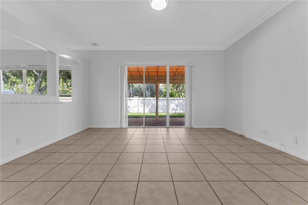 The family room is across from the kitchen and features the sliding doors to the back patio.