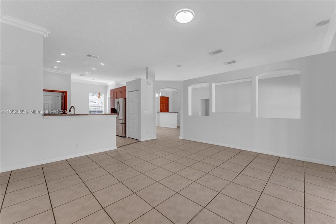 Looking from the family room towards the kitchen and the living/dining area beyond to the right.