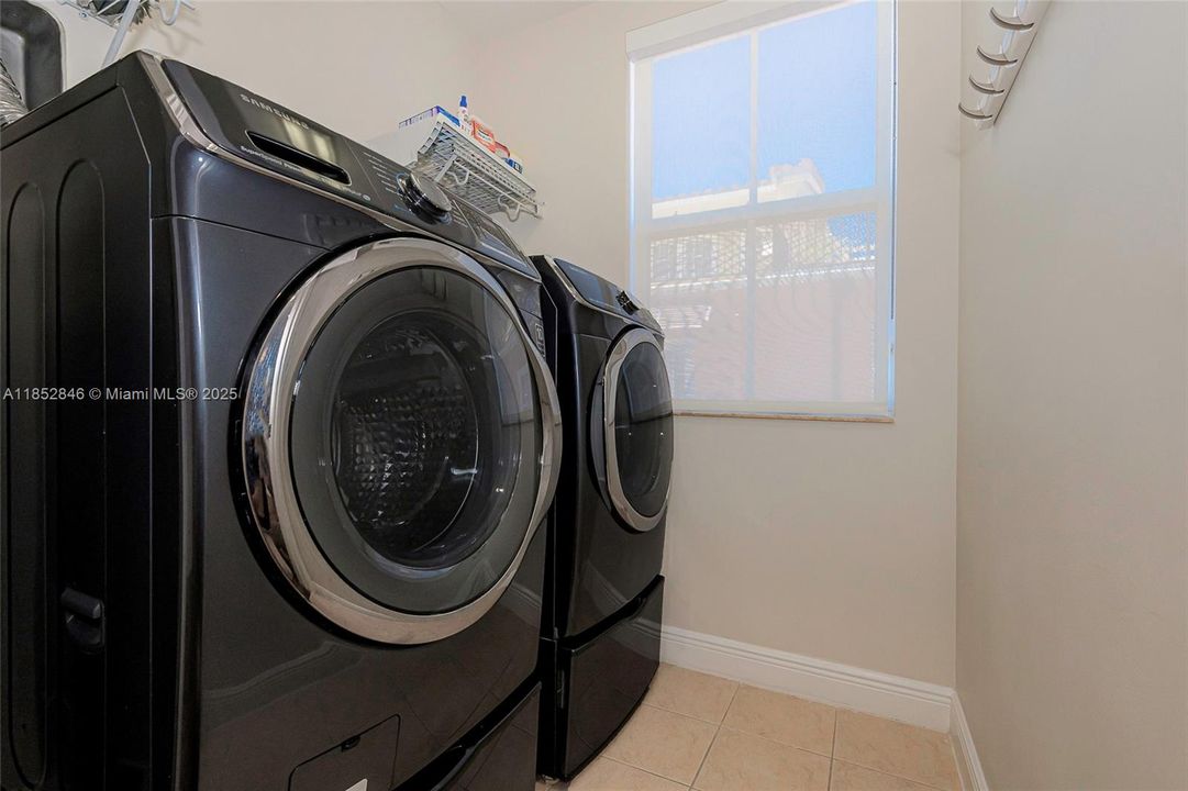 Laundry room with Samsung full size washer and dryer