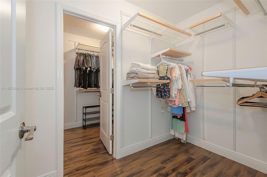 Primary bedroom walk in closet