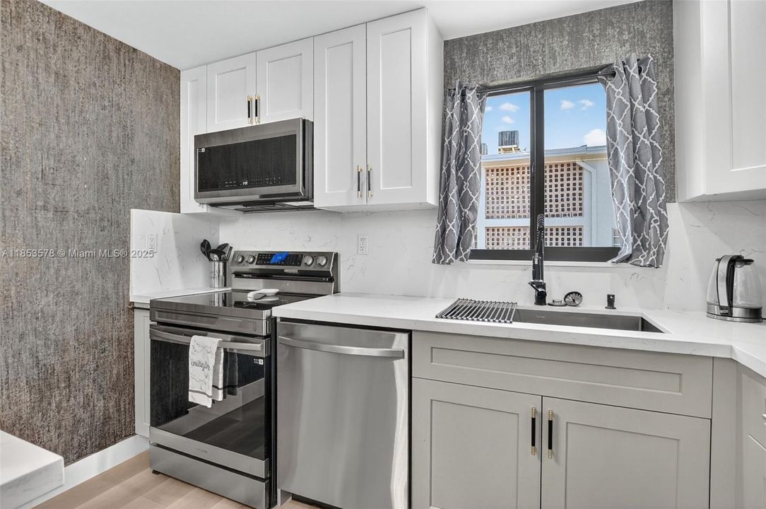 New appliances and large sink and sensor faucet! Extra spice cabinet next to stove!