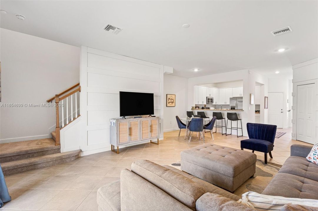 The open-concept main level is adorned w/ durable tile flooring & filled with natural light.