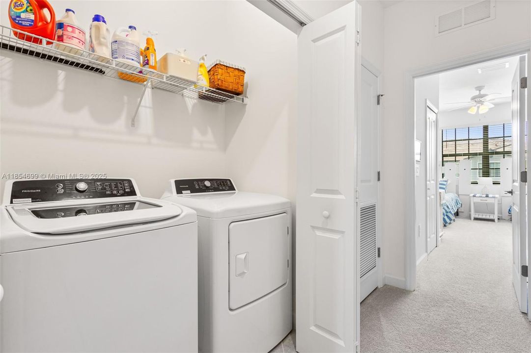 The ensuite bath offers granite countertops, dual sinks & glass-enclosed walk-in shower.