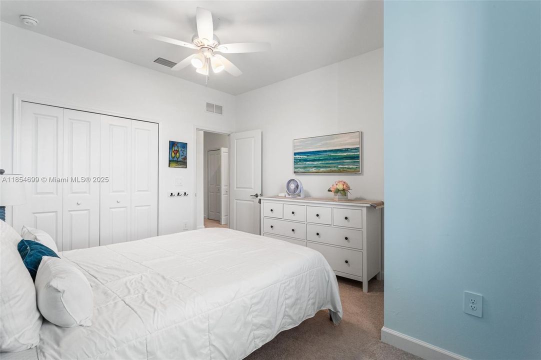 The upstairs laundry area is equipped with a washer, dryer, and shelving for supplies.