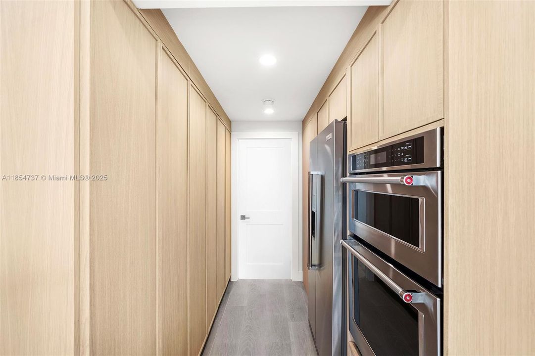 Pantry hallway connects to the fourth bedroom